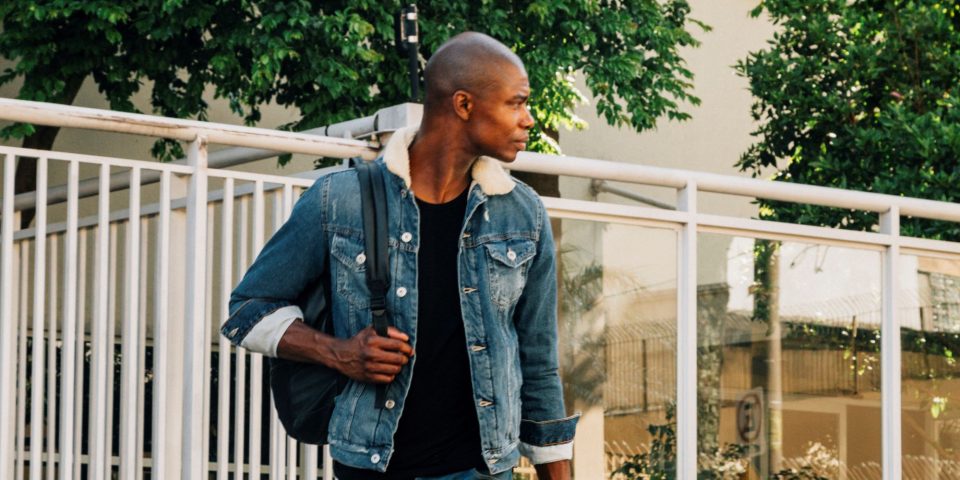 portrait-african-young-man-with-his-backpack-shoulder-looking-away